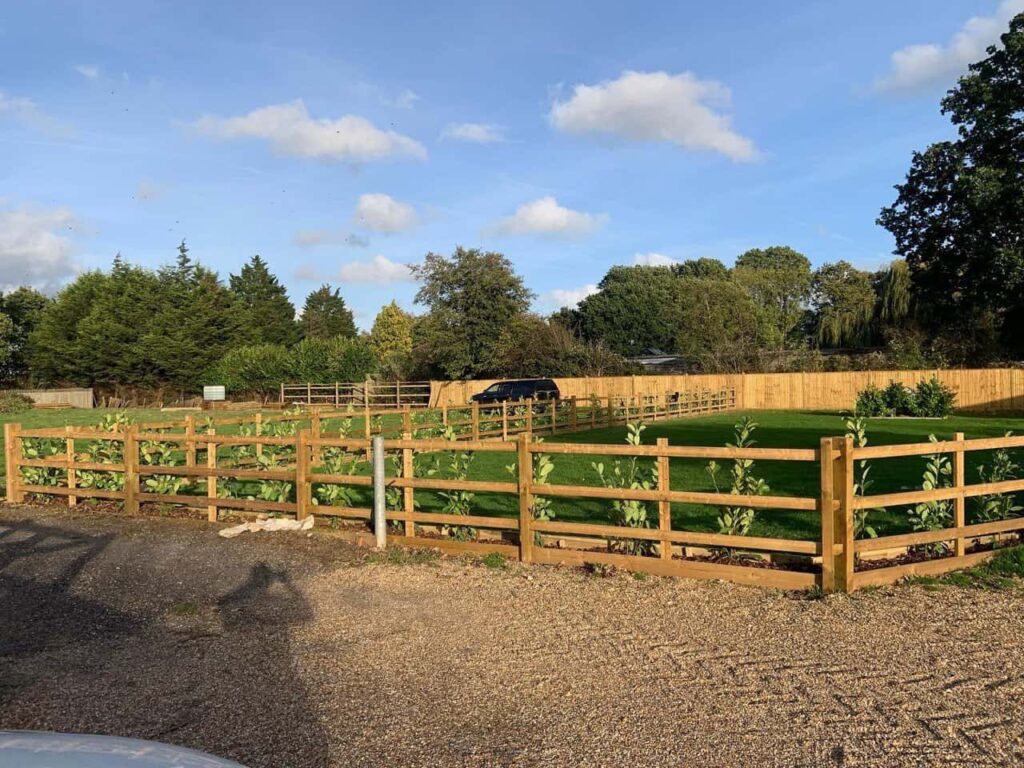 This is a photo of post and rail fencing with a gravel board installed at the base to create a flower bed, and at the rear is feather edge fencing along the edge of the garden. All works carried out by Fast Fix Fencing Attleborough